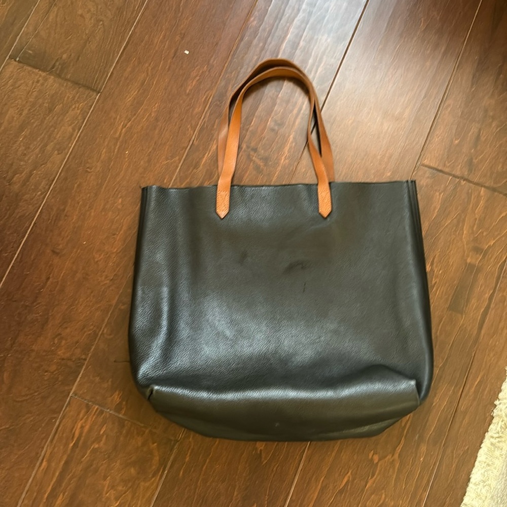 The Madewell transport tote in black and tan leather
